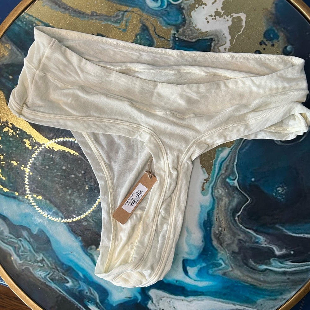 Skims Soft Smoothing Seamless thong in ‘Bone’